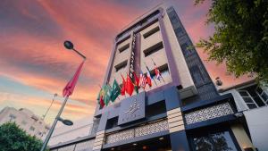 a building with flags on the side of it at Razane Hôtel in Kenitra