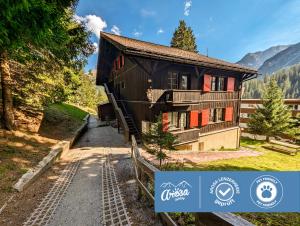 a house in the mountains with a train station at Chalet Pradella by Arosa Holiday in Arosa
