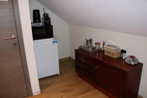 a room with a refrigerator and a dresser with a microwave at STUDIO TOUT CONFORT in Soignies