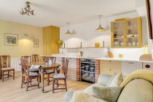 a kitchen and living room with a table and chairs at Horseshoe Cottage Farm with Hot Tub in Leicester