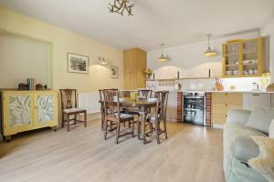 a kitchen and dining room with a table and chairs at Horseshoe Cottage Farm with Hot Tub in Leicester