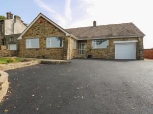 a brick house with two garage doors on a driveway at Copper Coin in Barnsley