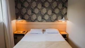Tempat tidur dalam kamar di Mako´s Hotel