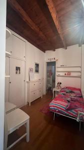a bedroom with a bed and a desk and a chair at A casa di Don Remo in Agnone