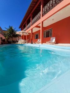 a swimming pool in front of a house at A S Suites in Angra dos Reis