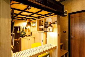 a small kitchen with a table and a refrigerator at 44 Room Rama 3 in Bangkok