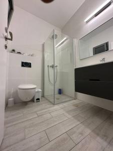 a white bathroom with a shower and a toilet at Elegant 3 bedroom Ocean view Condo in Kiryat Yam in Qiryat Yam