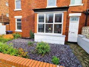 a front door of a brick house with a garden at Tower Views 2 Bedroom House with Private Parking in Blackpool