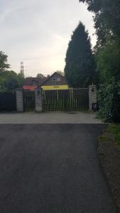 a fence in front of a house with a gate at Turystyczny apartament na poddaszu in Skoczów