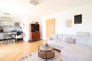 a living room with a couch and a table at Naturtalente Berghaus - Apartment 1 in Innerschwand am Mondsee