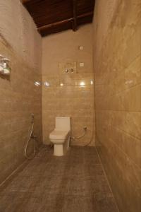 a bathroom with a toilet in a room at Brahmaputra cafe and resort in Bhundsi