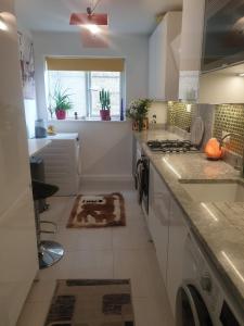 a kitchen with a sink and a stove at Beautiful Apartment in High Wycombe in Buckinghamshire