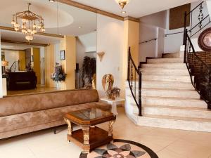 a living room with a couch and a table at Tagzzz Hotel powered by Cocotel in Tagaytay
