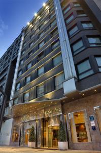 a tall building with plants in front of it at Hotel Gran Via in Logroño