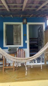a living room with a hammock in a house at Céu Azul Pousada in Arraial d'Ajuda