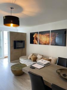 a living room with a table and a couch at Leilighet ved sjøen med strand in Porsgrunn