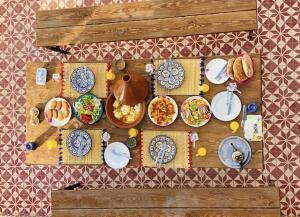 a table with plates of food on it at Binic guest house in Taghazout +62 photos
