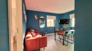 a living room with a red couch and a table at Afonso Galo Guest Apartments IV in Almada
