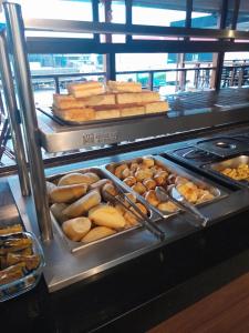 a buffet line with different types of bread and pastries at Hotel Colibri 