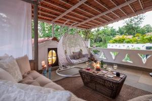 a living room with a couch and a swing at LohonoStays Castello Villa 5 in Vagator