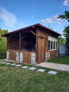 a large wooden dog house in the grass at Casa Dana Scorțeni 