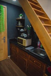 una cucina con lavello e forno a microonde su un bancone di Cozy Lovely Home + Netflix @District 1 ad Ho Chi Minh