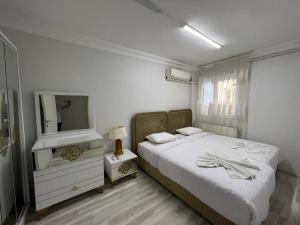 a bedroom with a bed and a dresser with a mirror at Taksim Beyoğlu Talimhane apart in Istanbul