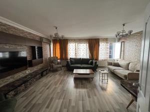 a living room with a couch and a tv at Taksim Beyoğlu Talimhane apart in Istanbul