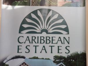 a sign for the caribbean est theatres at Caribbeans Estates Villa 45 Calypso Drive in Port Edward