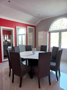 a dining room with a table and chairs at Caribbeans Estates Villa 45 Calypso Drive in Port Edward