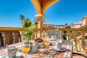 a table with wine glasses on a balcony at Villa Casita - PlusHolidays in Calpe