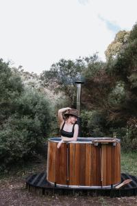 a woman in a hat sitting in a hot tub at Chambré Estate in Margaret River Town