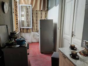 a kitchen with a refrigerator and a stove in it at Jessi on Marjanishvili in Tbilisi City