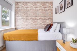 a bedroom with a brick wall and a bed at Alpha House by Night Stay: Contractors Sleeps 8 in Birmingham