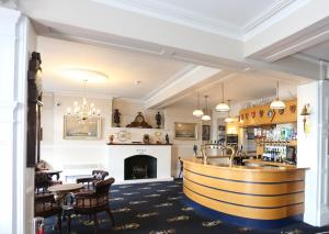 a bar in a restaurant with a fireplace at Royal Temple Yacht Club in Ramsgate