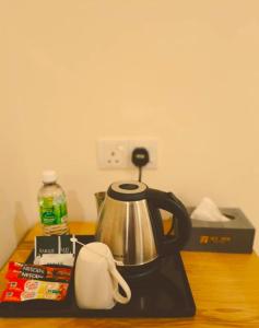a tea kettle sitting on top of a counter at My Inn Hotel Inanam in Inanam