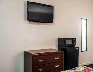 a room with a tv on the wall and a microwave at Express Inn-Rahway in Rahway