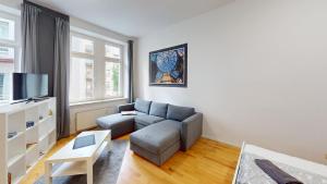 a living room with a couch and a tv at zentrales Loft mitten in Leipzig in Leipzig