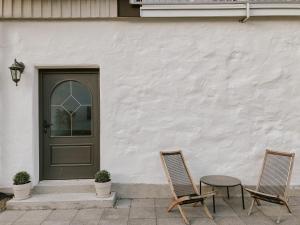 two chairs and a door in front of a house at Backhaus Efringen-Kirchen in Efringen-Kirchen