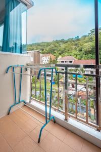 a balcony with a view of a city at Nice to meat you Rooms in Patong Beach