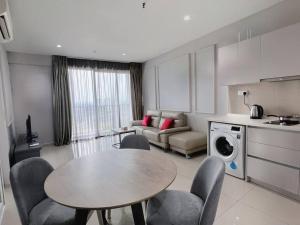 uma cozinha e sala de estar com mesa e cadeiras em Comfy Staycation 4PX with Free Parking, Direct Linked SOGO & Central I-CITY em Shah Alam