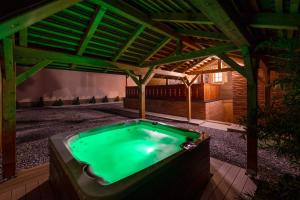a hot tub in a backyard with a pergola at Vila IVAN in Velika Gorica