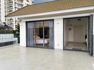 a room with sliding glass doors on a balcony at Villa near the Beach with 5bedroom VIP in Vung Tau