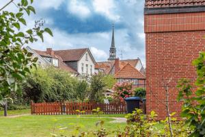 a town with a church steeple in the background at Traumhaftes Domizil mit Tiefgarage in Stade