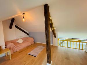a attic room with a bed and a wooden floor at Loft in 1902 Art-Nouveau Villa in Oradea +26 photos