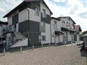 a black and white building with stairs in a parking lot at Trzy Korony Świecie in Świecie