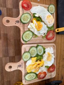 two wooden cutting boards with eggs and vegetables on them at Retro Khe Sanh in Lao Bao +33 photos
