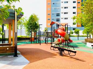 a playground with a slide in a park at UMAR HOMESTAY - Alanis KLIA in Sepang