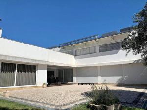 duży biały budynek z patio przed nim w obiekcie Casa do Pinheiro w mieście Fiães
