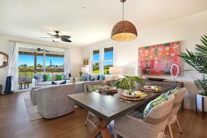 a living room with a table and chairs at Pili Mai 6K in Koloa